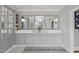 Bathroom featuring double sinks, elegant lighting, and ample storage space with cabinets at 8416 Davishire Dr, Raleigh, NC 27615