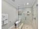 Bright bathroom featuring a glass shower, tiled walls, and stylish fixtures at 8416 Davishire Dr, Raleigh, NC 27615