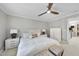 Bedroom with white bedding, white nightstands, and shuttered windows with natural light at 8416 Davishire Dr, Raleigh, NC 27615