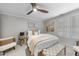 Cozy bedroom features a ceiling fan, neutral walls, and lots of natural light through shuttered windows at 8416 Davishire Dr, Raleigh, NC 27615