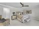 Bedroom boasts a gray upholstered bed, ceiling fan, and mirrored nightstands at 8416 Davishire Dr, Raleigh, NC 27615
