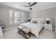 Bedroom with white bedding, white nightstands, and shuttered windows with natural light at 8416 Davishire Dr, Raleigh, NC 27615