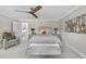 Bedroom boasts a gray upholstered bed, ceiling fan, and mirrored nightstands at 8416 Davishire Dr, Raleigh, NC 27615