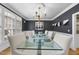 Elegant dining room with hardwood floors, wainscoting, and sophisticated lighting at 8416 Davishire Dr, Raleigh, NC 27615