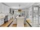 Elegant dining room featuring a wooden table, linen chairs, stylish lighting, and access to outdoor area at 8416 Davishire Dr, Raleigh, NC 27615