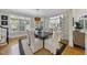 Bright dining room with large windows, white chairs, and a wooden table perfect for entertaining at 8416 Davishire Dr, Raleigh, NC 27615