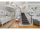 Grand foyer with curved staircase, hardwood floors, and elegant wainscoting at 8416 Davishire Dr, Raleigh, NC 27615