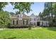 Charming two-story home with lush landscaping, a well-manicured lawn, and a stone and siding facade at 8416 Davishire Dr, Raleigh, NC 27615