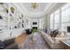 Elegant living room with custom built-ins, fireplace, hardwood floors, and tray ceiling at 8416 Davishire Dr, Raleigh, NC 27615