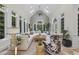 Inviting living room featuring large windows, a vaulted ceiling, and stylish neutral furnishings at 8416 Davishire Dr, Raleigh, NC 27615