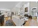 Open-concept living room with modern decor, a fireplace, and seamless access to the dining area at 8416 Davishire Dr, Raleigh, NC 27615