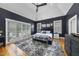 This main bedroom has a vaulted ceiling, an accent wall, wood floors and an exterior door to a private lanai at 8416 Davishire Dr, Raleigh, NC 27615