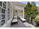 Inviting outdoor patio with chaise lounges, black railings and lush landscaping at 8416 Davishire Dr, Raleigh, NC 27615