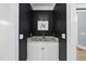 Stylish powder room with granite countertop, modern fixtures, and dark accent wall at 8416 Davishire Dr, Raleigh, NC 27615