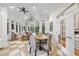 Light-filled sunroom with vaulted ceilings, neutral decor, dining table, and multiple windows at 8416 Davishire Dr, Raleigh, NC 27615