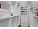Bright walk-in closet with built-in shelving and hanging racks for optimal organization at 8416 Davishire Dr, Raleigh, NC 27615