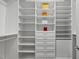 Walk-in closet featuring custom shelving and drawers for organized storage at 8416 Davishire Dr, Raleigh, NC 27615