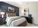 A stylish bedroom features a dark accent wall, natural light, a nightstand, and chic decorations at 88 Freedom Heights Ln # 148, Smithfield, NC 27577