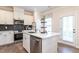 Beautiful kitchen featuring stainless steel appliances, a kitchen island and dark backsplash at 88 Freedom Heights Ln # 148, Smithfield, NC 27577