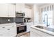 Bright kitchen featuring modern appliances, white cabinets and a sleek countertop at 88 Freedom Heights Ln # 148, Smithfield, NC 27577