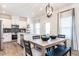 Bright eat-in kitchen with stainless steel appliances, white cabinets, and a modern lighting fixture at 88 Freedom Heights Ln # 148, Smithfield, NC 27577