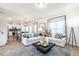 Open-concept living room with stylish furniture, large windows, and seamless flow to the kitchen at 88 Freedom Heights Ln # 148, Smithfield, NC 27577