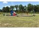This outdoor community playground is landscaped with playground equipment and benches at 88 Freedom Heights Ln # 148, Smithfield, NC 27577