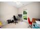 Bright bedroom with a ceiling fan, large window and desk ideal for a home office or study space at 904 E Ivy Valley Dr, Fuquay Varina, NC 27526