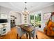 Cozy dining area featuring a wooden table, comfortable chairs, a chandelier, and views of the backyard at 904 E Ivy Valley Dr, Fuquay Varina, NC 27526