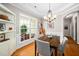 Bright dining room showcasing a wood table, stylish chairs, elegant lighting, and view to outside at 904 E Ivy Valley Dr, Fuquay Varina, NC 27526