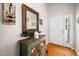 Inviting entryway featuring hardwood floors, a decorative mirror, and a charming green cabinet at 904 E Ivy Valley Dr, Fuquay Varina, NC 27526