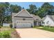 Charming single-Gathering home with a two-car garage, manicured lawn and a walkway leading to the front door at 904 E Ivy Valley Dr, Fuquay Varina, NC 27526
