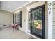Close up of front door with glass and bench on porch at 904 E Ivy Valley Dr, Fuquay Varina, NC 27526