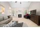 Bright living room with fireplace, plush seating, vaulted ceilings, and neutral decor providing a cozy and inviting atmosphere at 904 E Ivy Valley Dr, Fuquay Varina, NC 27526
