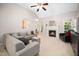Spacious living room with a fireplace, plush seating, a high ceiling, and plenty of natural light at 904 E Ivy Valley Dr, Fuquay Varina, NC 27526
