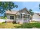 Exterior of house with screened-in porch, brick foundation, and green lawn at 904 E Ivy Valley Dr, Fuquay Varina, NC 27526