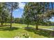 Lush backyard with mature trees and views of the golf course at 904 Parkridge Dr, Clayton, NC 27527