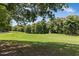 Expansive green backyard with manicured lawn and wooded perimeter for privacy at 904 Parkridge Dr, Clayton, NC 27527