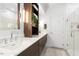 Modern bathroom featuring double sinks, marble countertops, and a glass-enclosed shower at 904 Parkridge Dr, Clayton, NC 27527