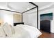 Well-lit bedroom with a TV, tray ceiling, and hardwood floors, offering a cozy and modern space at 904 Parkridge Dr, Clayton, NC 27527