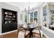 Sun-filled breakfast nook features large windows, black shelving, and hardwood flooring at 904 Parkridge Dr, Clayton, NC 27527