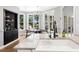 Sunny breakfast nook features large windows with backyard views and stylish black shelving at 904 Parkridge Dr, Clayton, NC 27527