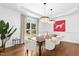 Elegant dining room featuring hardwood floors, a modern chandelier, and large windows with views of the outdoors at 904 Parkridge Dr, Clayton, NC 27527