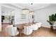 Elegant dining room features hardwood floors, modern light fixtures, and seating for ten at 904 Parkridge Dr, Clayton, NC 27527