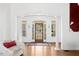 Bright entryway with hardwood floors, white trim, and a view of the front yard through a glass-paneled front door at 904 Parkridge Dr, Clayton, NC 27527