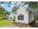 Charming view of a white-sided home with black shutters and an arched window, complemented by lush landscaping at 904 Parkridge Dr, Clayton, NC 27527