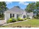 Side view of a white-sided home with black shutters, lush landscaping, and a well-manicured lawn, showcasing curb appeal at 904 Parkridge Dr, Clayton, NC 27527