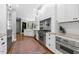 Bright kitchen boasts stainless steel appliances, custom cabinetry, and hardwood flooring at 904 Parkridge Dr, Clayton, NC 27527