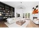 Bright living room featuring a cozy fireplace, custom built-ins and large windows overlooking the backyard at 904 Parkridge Dr, Clayton, NC 27527