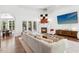 Bright living room with hardwood floors, a cozy fireplace, and large windows overlooking the backyard, perfect for gatherings at 904 Parkridge Dr, Clayton, NC 27527